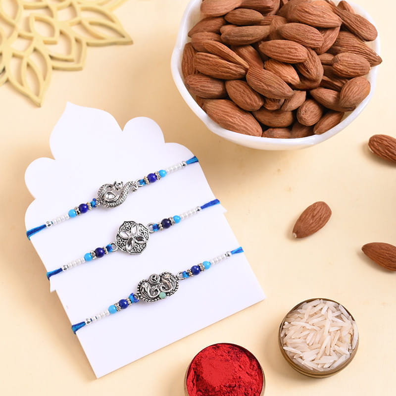 Peacock N Floral Rakhi Trio With Almonds