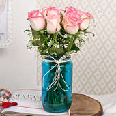 Arrangement of 12 Pink Roses in a Blue Jar Vase