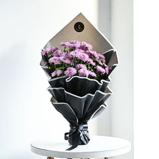 Purple Daisy 7 Stems In A Black Paper Wrap