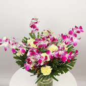 Arrangement of 4 Purple Orchids and 10 Yellow Carnations