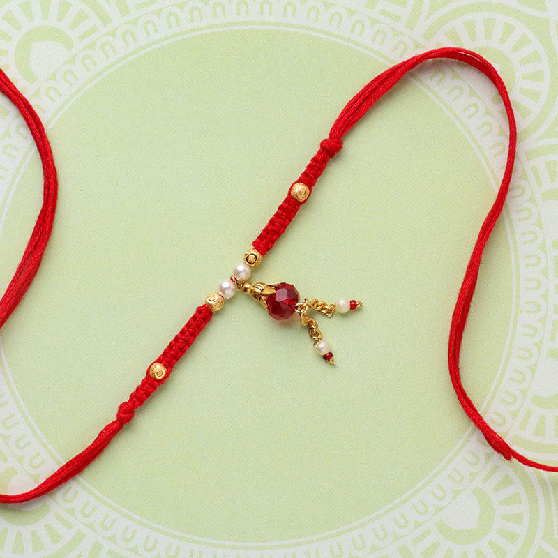 Radiant Red Stone And Pearl Rakhi