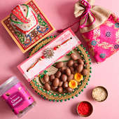 Open box sweets in thali with rakhi