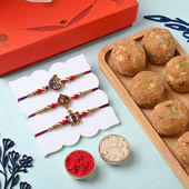 Red N Blue Divine Rakhis With Ladoos