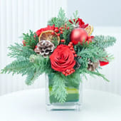 Red Roses N Xmas Foliage In Vase