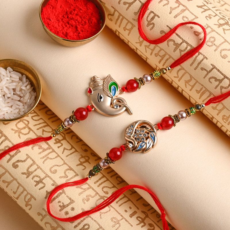 Send Divine rakhi For Brother Online - Rose Gold Ganesha And Swan Rakhi Duo