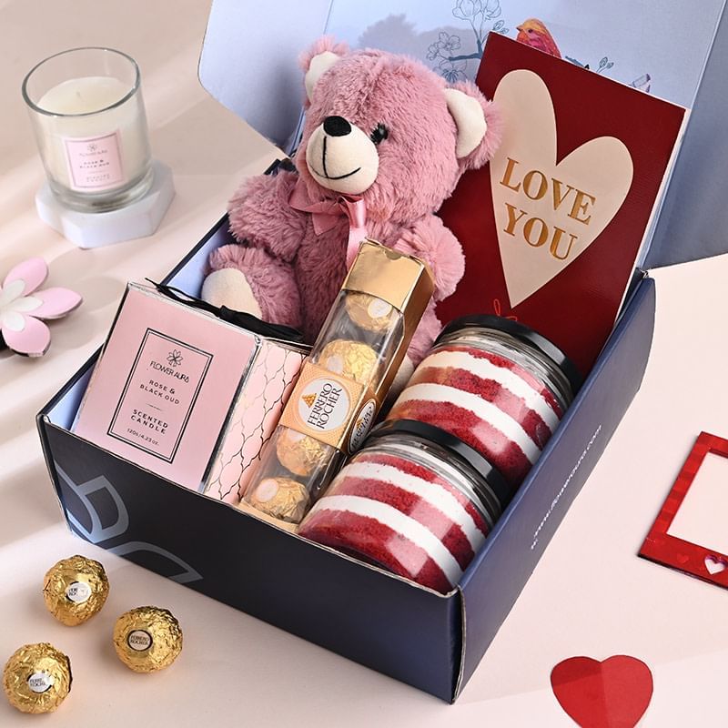 Cuddly Love Hamper with 6-inch teddy, 'Love You' card, 4 Ferrero Rocher chocolates, 2 red velvet jar cakes, and a rose & oud candle