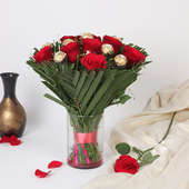 Roses N Ferrero Rocher:Arrangement of 8 Red Roses and 8 Ferrero Rochers in a Glass Vase