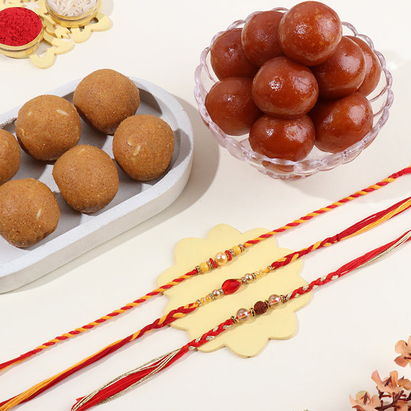 Rudraksha N Pearl Rakhi Trio With Classic Sweets