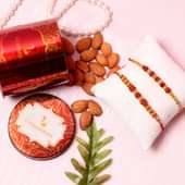 Rudraksha Nut Rakhi Combo - Set of 2 Designer Rakhi with Complimentary Roli and Chawal and 100gm Almonds in Red Floweraura Container