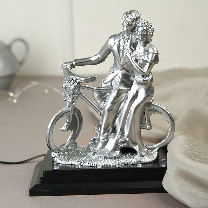 Satiny Couple On Bicycle