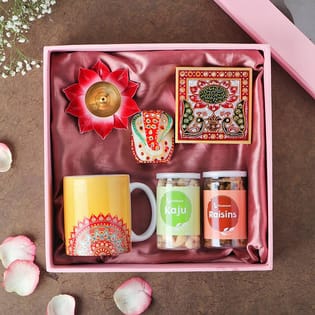 Lord Ganesha on chauki, coffee mug, lotus diya & dry fruits Buy Now