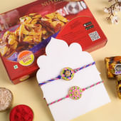 Set Of Two Floral Motif Rakhis With Nutty Sweets