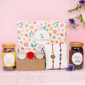 Sibling Signature Box - Set of 2 Designer Rakhis with Complimentary Roli and Chawal and 100gm Choco Almonds in Plastic Container and 100gm Choco Cashews in Plastic Container and One Floweraura Signature Box