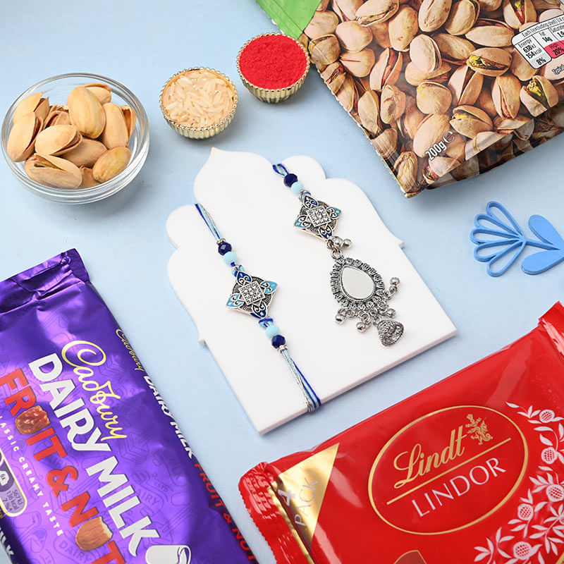 Silver Couple Rakhi With Lindt N Cadbury