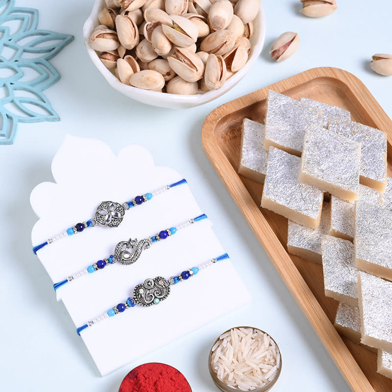 Silver Motifs Rakhi Trio With Sweets N Nuts