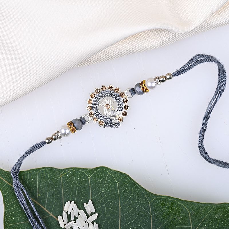 Rakhi in Stunning Silver Peacock Rakhi - Peacock silver rakhi