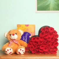 35 Red roses hearshaped 12 inches cream colored teddy cadbury celebation