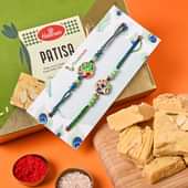 Buy Set of 2 Rakhi Online For Brotherwith Sweets - Tasty N Healthy Patisa Meethai With Beautiful Peacock Rakhi Duo