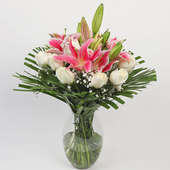 Arrangement of 4 Pink Lilies and 12 White Carnations in a Glass Vase