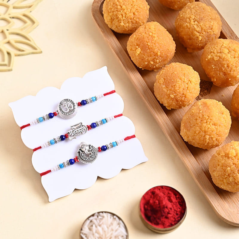 Three Divine Silver Rakhis With Besan Laddu