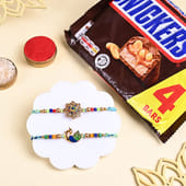 Two Floral Peacock Rakhis With Snickers