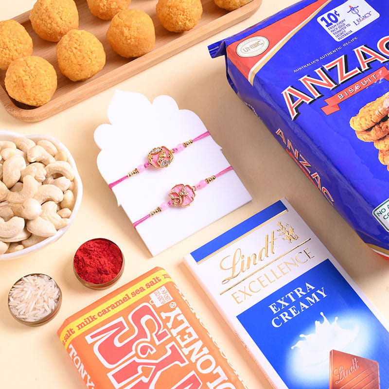 Two Floral Pink Rakhis N Sweet Feast Hamper