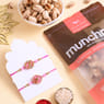 Two Floral Pink Rakhis With Nutty Treats