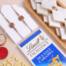 Two Floral Stone Rakhis With Sweets N Chocolate