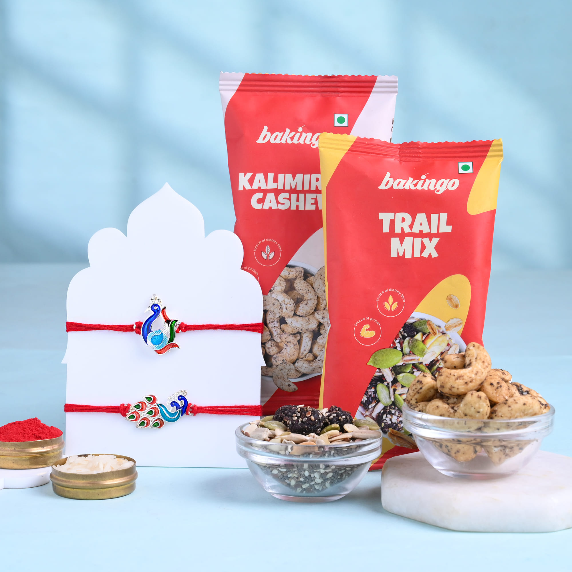 Two Graceful Peacock Rakhis With Festive Treats