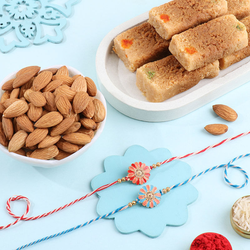 Two Pastel Floral Rakhis With Almonds N Milk Cake