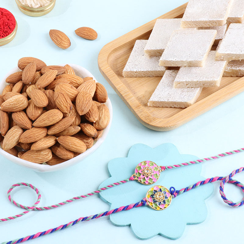 Two Pastel Floral Rakhis With Kaju Katli N Almonds