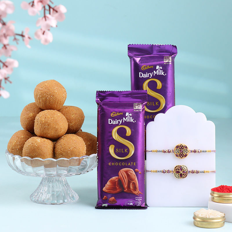 Two Purple Floral Rakhis With Choco N Laddoo-Singapore